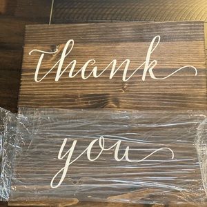 2 wooden signs that say “thank” & “you”